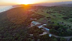 an aerial view of a house with the sunset in the background at Ocean Sounds in Gqeberha