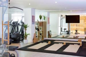 a living room with a gym with a television and a gym at Meliá Cala Galdana in Cala Galdana