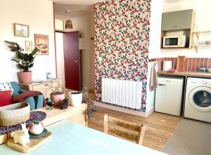 a living room with a kitchen and a living room with a dishwasher at Inspired space in Le Mans