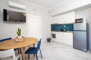 a kitchen with a wooden table and a refrigerator at Adorable Modern Guesthouse 3 in Perea