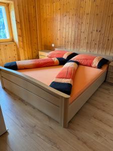 a bedroom with two beds in a wooden room at Accogliente appartamente a Pedecosta in Poschiavo +8 photos