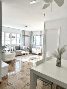 a living room with a couch and a table at Chalets con piscinas privadas junto al mar in Cala'n Bosch +53 photos