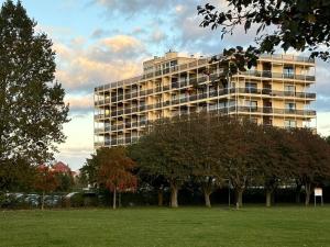 a large building with trees in front of it at Ferienwohnung kleiner Sonnenschein Großenbrode Ostsee in Grossenbrode