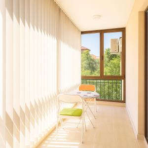 a room with a table and two chairs and a window at Star Dreams Apartment with Glass Veranda in Sveti Vlas