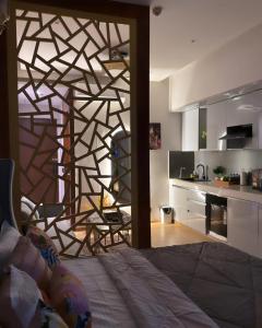 a bedroom with a wooden wall with a kitchen at Square Residency in Ghaziabad +14 photos