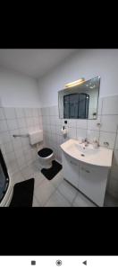 Un baño blanco con lavabo e inodoro. en App VITO, en Senj
