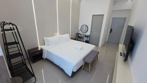 Ein Bett oder Betten in einem Zimmer der Unterkunft One Point Hotel TT3 Tabuan Tranquility