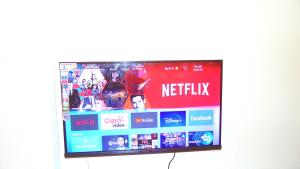 a flat screen tv hanging on a wall at Vera Cruiz one bedroom CBD in Malindi +12 photos