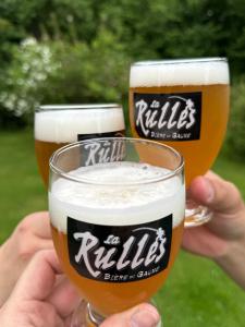 two people holding up two glasses of beer at Arduinna's Nest B&B in Neufchâteau