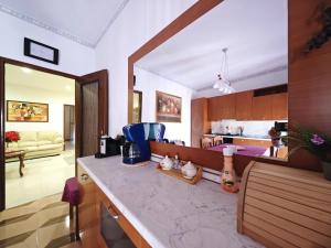 a kitchen with a counter top and a kitchen with a counter top at Valparadiso Apartment in Naro