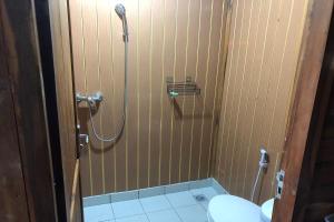 a bathroom with a shower and a toilet at Munduk Terrace in Munduk