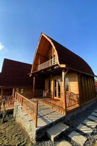 a large wooden house with a large deck at Munduk Terrace in Munduk