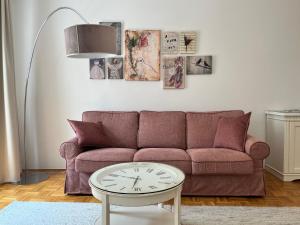 a living room with a couch and a table at City Pearl Apartment in Ljubljana