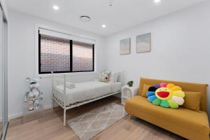 a room with a couch and a bed and a window at New, Comfy & Fully Equipped 3BR Home in Kellyville in Glenwood