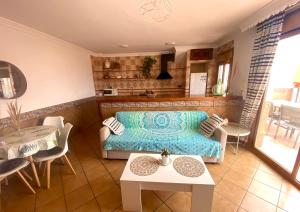 a living room with a couch and a table at Ático Lanjarón in Lanjarón