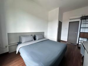 a bedroom with a large bed with white sheets and pillows at The Moonlight Valley Sri Indah in Sandakan +17 photos