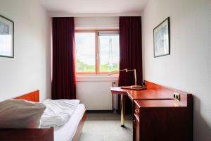 Ein Bett oder Betten in einem Zimmer der Unterkunft Bettenburg Hotel & Hostel