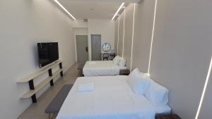 Ein Bett oder Betten in einem Zimmer der Unterkunft One Point Hotel TT3 Tabuan Tranquility
