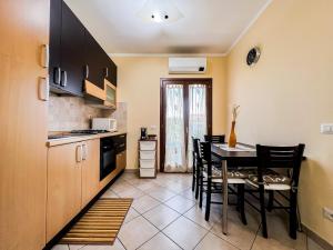 a kitchen and dining room with a table and chairs at Ginestra house in Olbia