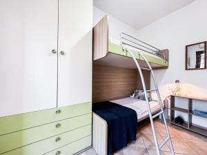 a small bedroom with a bunk bed and a desk at Ginestra house in Olbia