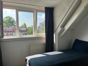 Ένα ή περισσότερα κρεβάτια σε δωμάτιο στο Family friendly Vacation home Vught - Den Bosch