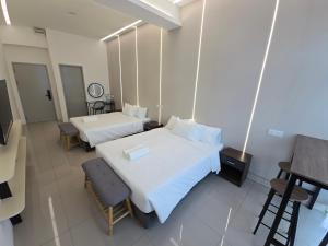Ein Bett oder Betten in einem Zimmer der Unterkunft One Point Hotel TT3 Tabuan Tranquility