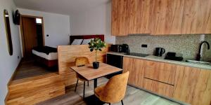 a kitchen with a table and chairs in a room at Foz House Sabor & Douro in Torre de Moncorvo
