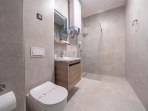 a bathroom with a toilet and a sink and a shower at CASA AL MARE RESIDENCE in Bečići