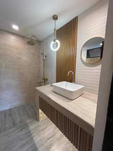 a bathroom with a sink and a mirror at Sitio Maupot Family Resort in Sampong