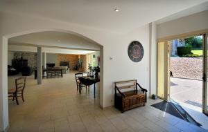 a living room with a table and chairs and a dining room at Le Logis du Marronnier in Perpezac-le-Noir