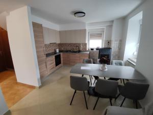 a kitchen and dining room with a table and chairs at Frane House in Knežak
