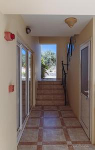 a hallway of a house with stairs and a door at Vrokastro Apartments in Istro