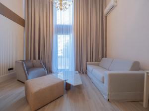 a living room with a couch and a chair at CASA AL MARE RESIDENCE in Bečići