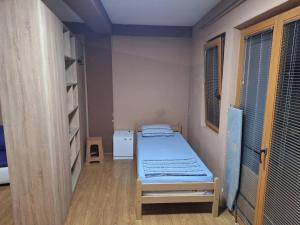 a small room with a bed and a window at Aparman JOKI in Ohrid