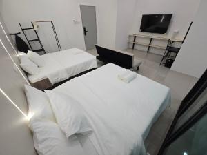 Ein Bett oder Betten in einem Zimmer der Unterkunft One Point Hotel TT3 Tabuan Tranquility