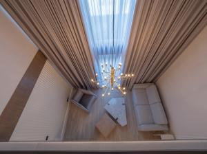 a ceiling view of a room with a chandelier at CASA AL MARE RESIDENCE in Bečići