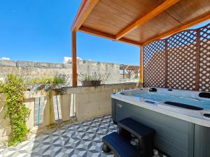 a jacuzzi tub in a pavilion with a view at Zebbuga Deluxe Lavish Suite 3 in Żebbuġ