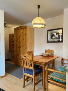 a dining room with a wooden table and chairs at Wichtel Haus in Oberau