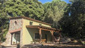 a small house with a picnic table in front of it at La Coma in gualba de Dalt