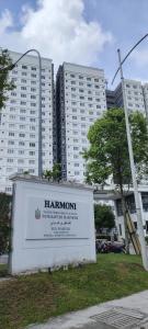 a sign in front of two tall buildings at J&K Guesthouse at Harmoni Apartment, Eco Majestic in Beranang