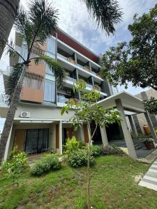 a building with a palm tree in front of it at Long Beach Hotel Pangandaran in Pangandaran
