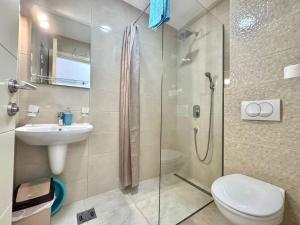 a bathroom with a shower and a toilet and a sink at Villa Ines in Budva +50 photos