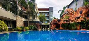 a large blue swimming pool in front of a building at Long Beach Hotel Pangandaran in Pangandaran