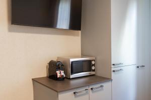 a microwave sitting on top of a counter in a kitchen at BetweenLakes Studio 2nd floor in Interlaken