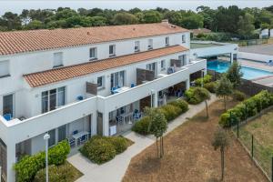 an aerial view of a building with a pool at Résidence Prestige Odalys Le Domaine des Pins in Noirmoutier-en-l'lle