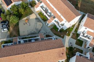 an overhead view of a building with a roof at Résidence Prestige Odalys Le Domaine des Pins in Noirmoutier-en-l'lle
