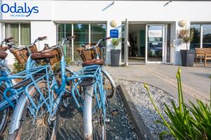 a group of blue bikes parked in front of a building at Résidence Prestige Odalys Le Domaine des Pins in Noirmoutier-en-l'lle