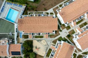an overhead view of two buildings with a pool at Résidence Prestige Odalys Le Domaine des Pins in Noirmoutier-en-l'lle