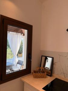a mirror sitting on a counter next to a window at CasaNica - Elegant independent apartment in Torpè +16 photos