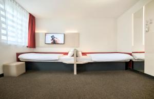 Postel nebo postele na pokoji v ubytování B&B HOTEL Katowice Centrum